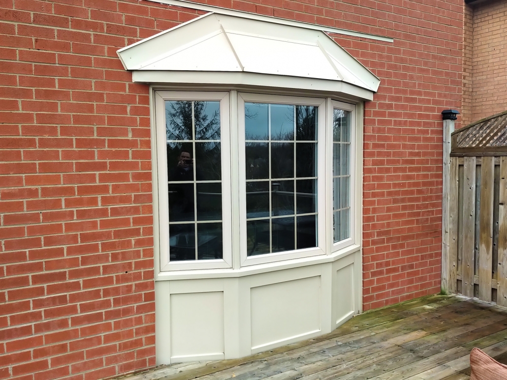 Bay / Bow Windows against a brick wall in Newmarket, ON by Simon and Sons